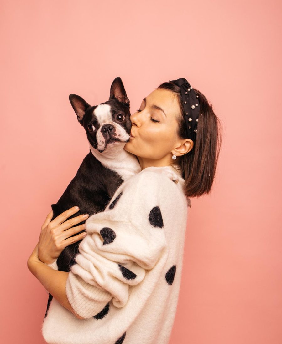 Woman smiling at her small black and white dog